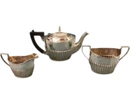 A hallmarked silver regency style three-piece tea service by William Aitken, the half-gadrooned oval