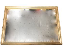 A contemporary gilt framed mirror in foliate moulded frame. (27.75in x 39.5in)