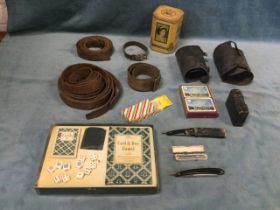 Miscellaneous collectors items - leather straps, razors, a 1953 tin caddy, cards & games, a pair