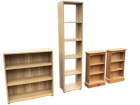 A pair of small pine bookcases with grooved tops above adjustable shelves on plinth bases - 31.25in;
