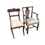 A Georgian style mahogany elbow chair with pierced splat and shaped arms above a needlework seat,