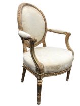 A nineteenth century carved Chippendale style giltwood armchair by Mellier & Co, the oval padded