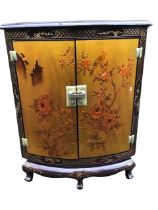 A Chinese lacquer corner cabinet, the curved moulded top with flower motif above a pair of doors