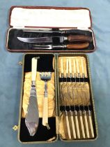 A cased three-piece carving set with silver plated collars and antler handles; and a six-place cased