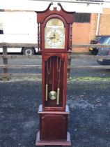 A mahogany grandmother clock by C Wood & Son, the swan-neck pediment above an arched metal dial with