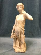 A carved Victorian marble figure of an elegant young lady holding flower, standing by stylised