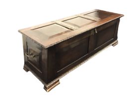 An arts & crafts mahogany coffer with hammered metal hinges to three-panelled top having ripple