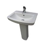 A contemporary ceramic pedestal washbasin with central chromed mixer tap and fittings. (22in x