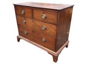 A Georgian mahogany chest of drawers, the moulded top above two short and two long drawers mounted