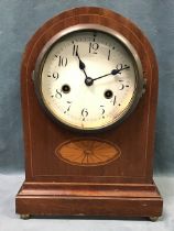 An Edwardian mahogany mantel clock, the arched case with inlaid satinwood fan motif and moulded base