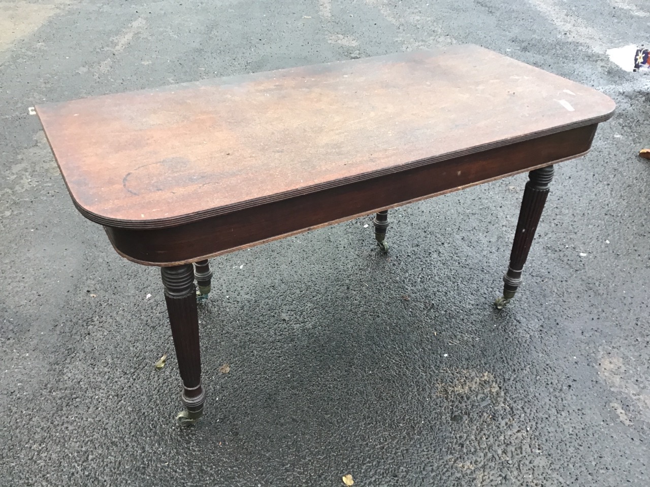 A Regency mahogany table, the rounded rectangular top and apron, raised on turned reeded legs with - Image 2 of 3