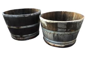 A pair of oak barrel type garden tubs, the staves bound by galvanised metal strap bands. (27.5in x