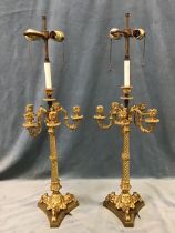 A pair of C19th ormolu seven-light candelabra, the scrolled arms on spiral fluted columns above