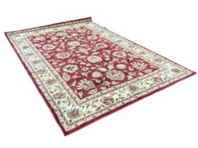 An American carpet, the claret field with Persian style scrolling flowerhead and foliate pattern,