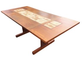 A Danish mid-century teak extending dining table, with two detachable leaves supported on lopers,