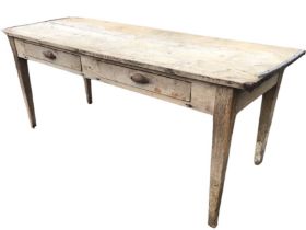 A nineteenth century 6ft pine table with wide board to top above two frieze cup handled drawers,