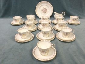 A Royal Crown Derby twelve-piece teaset decorated in the Harvest Poppy pattern with gilded rims. (