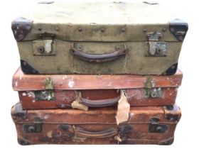 Three C20th suitcases - canvas covered with leather corners & handle and brass locks retailed by