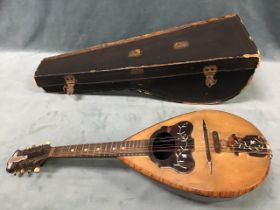 A leather cased 19th century Italian eight-string mandolin, with kingwood purfling framing a pine