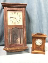 A walnut mantleclock in architectural style case framed by turned columns, the silvered dial with