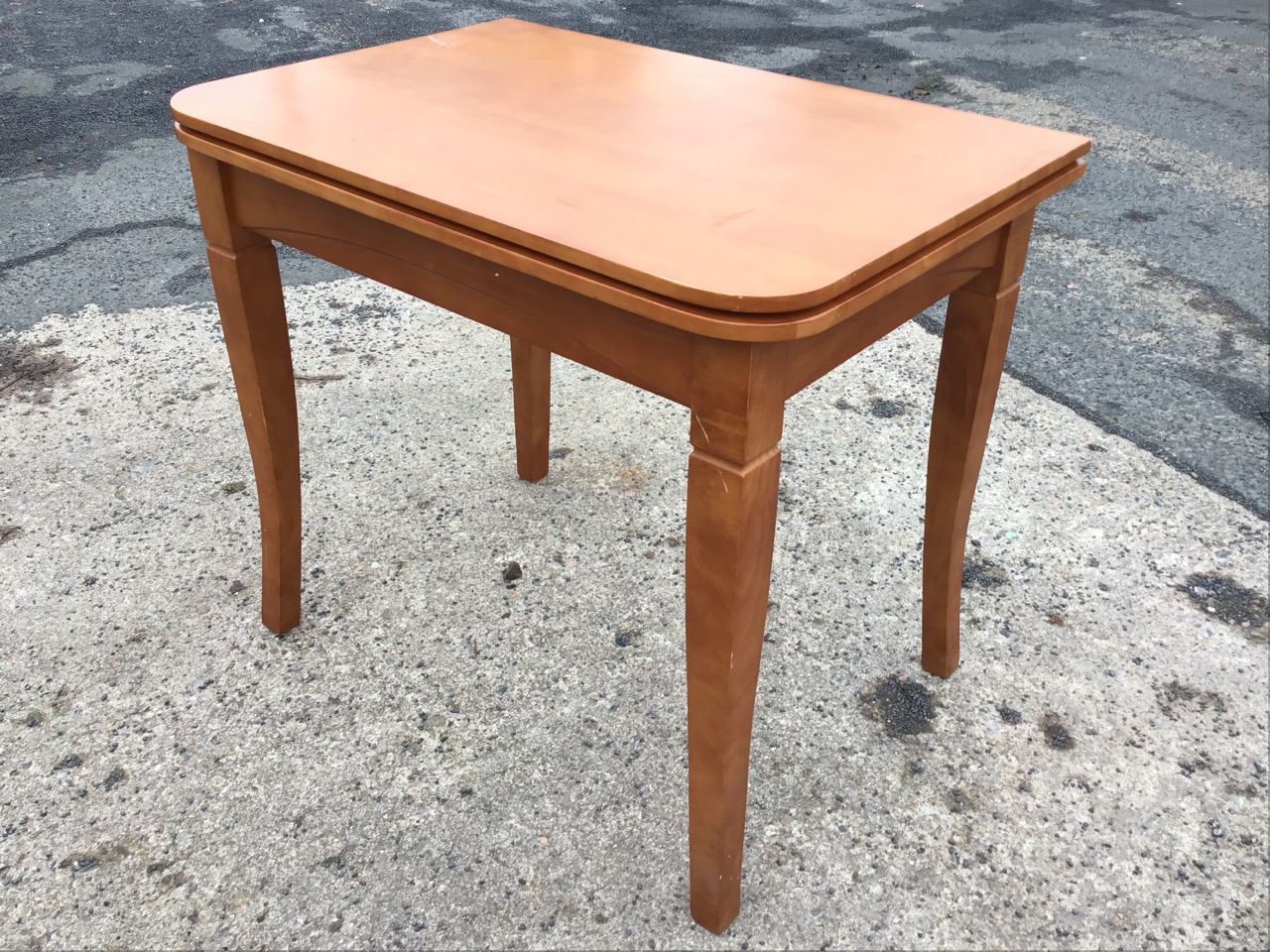 A pale mahogany fold-over dining table, the rounded rectangular top above an apron raised on everted - Image 2 of 3