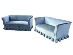 A pair of upholstered two-seater sofas, the low rectangular backs flanked by outscrolled arms