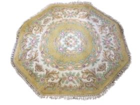A Chinese octagonal rug, the yellow field with floral garland medallion, within a scrolling
