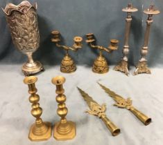 A pair of Victorian brass candlesticks; a tall foliate embossed tubular wine cooler on stand; a pair