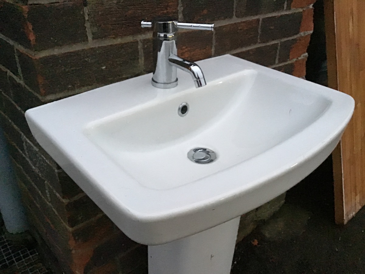 A contemporary ceramic pedestal washbasin with central chromed mixer tap and fittings. (22in x - Image 2 of 3