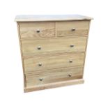 A contemporary oak chest of drawers, the rectangular top above two short and three long knobbed