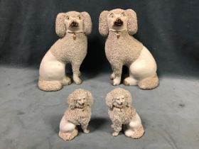 A pair of Victorian flatback wally dogs seated on their haunches with painted faces, gilt collars