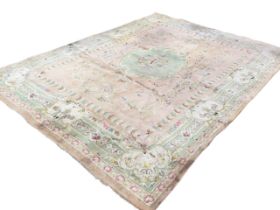 An Aubusson style thick wool carpet woven with central oval green floral medallion on pink field