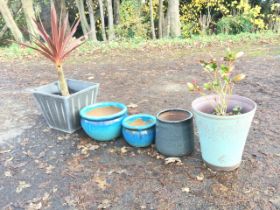 Five miscellaneous plant pots - lustre glazed cauldron type, plastic, scroll decorated, faux wood,