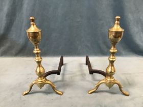 A pair of Georgian style brass and wrought iron andirons, the turned columns with urn shaped finials