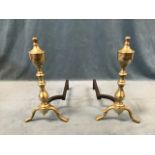 A pair of Georgian style brass and wrought iron andirons, the turned columns with urn shaped finials