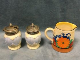 A Clarice Cliff cream jug handpainted in the bright floral Gayday pattern; and a pair of Locke