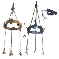 A pair of wrought iron hanging light fittings with scrolled rings hung from chains and leaf