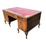 A mahogany pedestal desk, the rectangular gilt-tooled leather inset top above a frieze of three