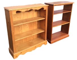 A pine open bookcase, the moulded rectangular top above a shaped apron and adjustable shelves