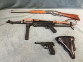 Three replica weapons - a Winchester style rifle, a leather cased Luger type handgun, and a
