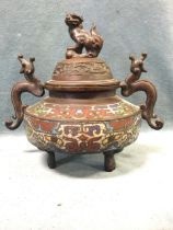 A nineteenth century Chinese bronze vessel, the domed cover with dog finial above a greek key