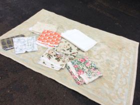 A Laura Ashley cotton rug woven in the Aubusson style with pale pastel floral decoration; and a