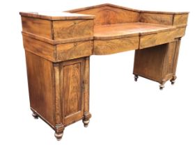 A William IV mahogany pedestal sideboard, the pedimented back above a bowed breakfront top with