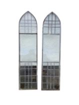 A pair of steel framed lancet windows, with leaded upper and lower panels. (18.25in x 77.5in) (2)