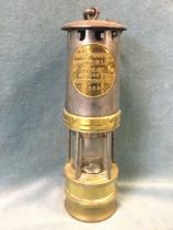 A steel and brass Hailwoods miners lamp by Siebe, Gorman & Co Ltd London, with tapering chimney