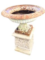 A Victorian cast iron campana garden urn with lozenge rim and fluted body on square plinth,