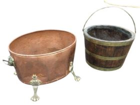 An oak bucket, the staves bound with riveted brass bands, mounted with swing handle; and an oval