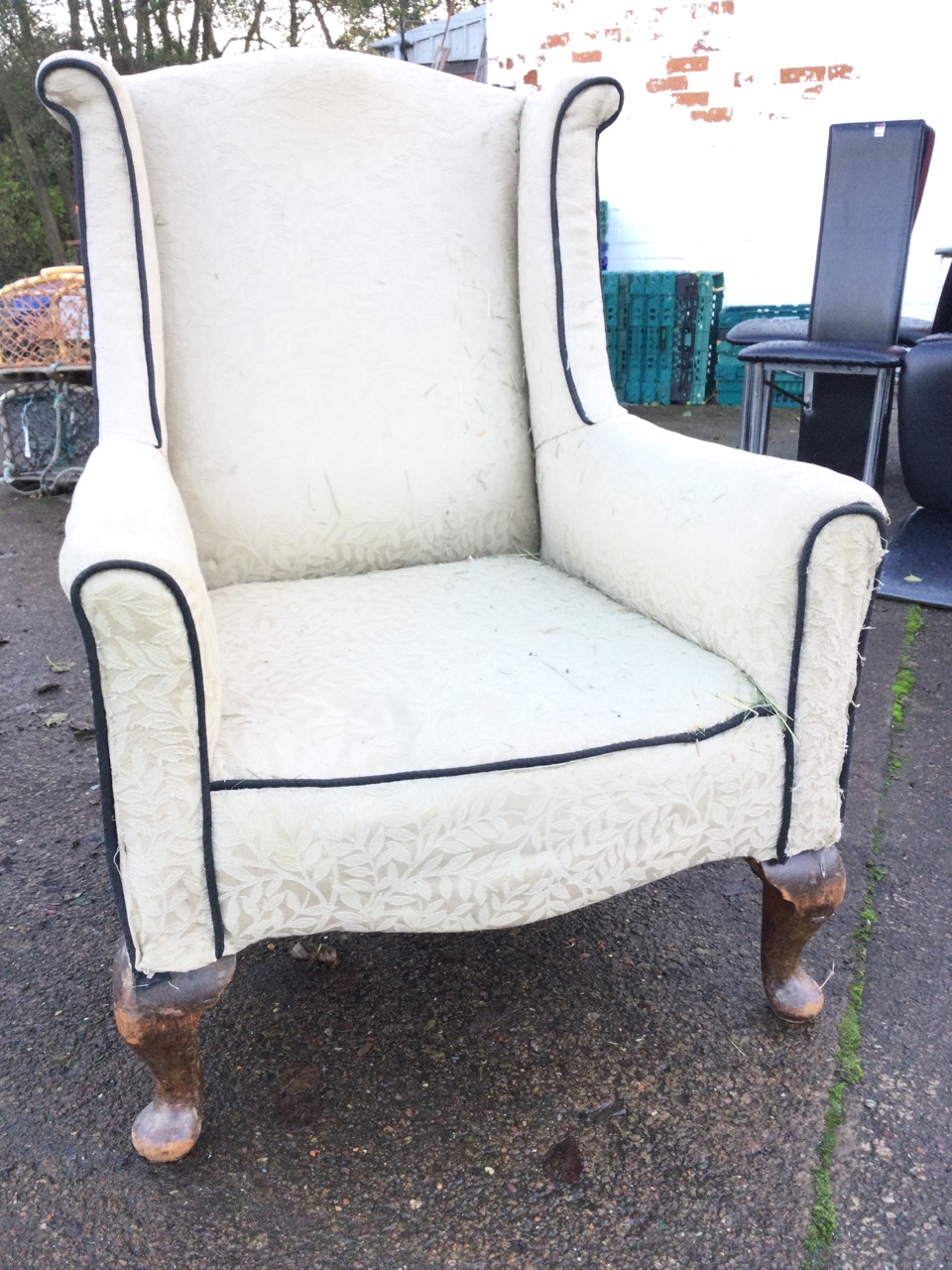 An Edwardian upholstered wing armchair, the arched back and outscrolled wings above a bowfronted - Image 2 of 3