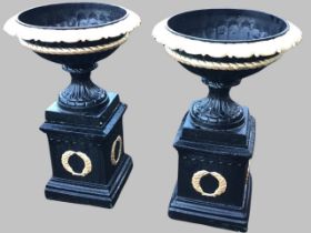 A pair of classical cast iron garden urns, with lobed rims, ropetwist and gadrooned bodies and