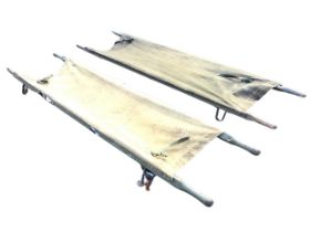 Two First World War military painted pine and canvas field stretchers, with wrought iron braces